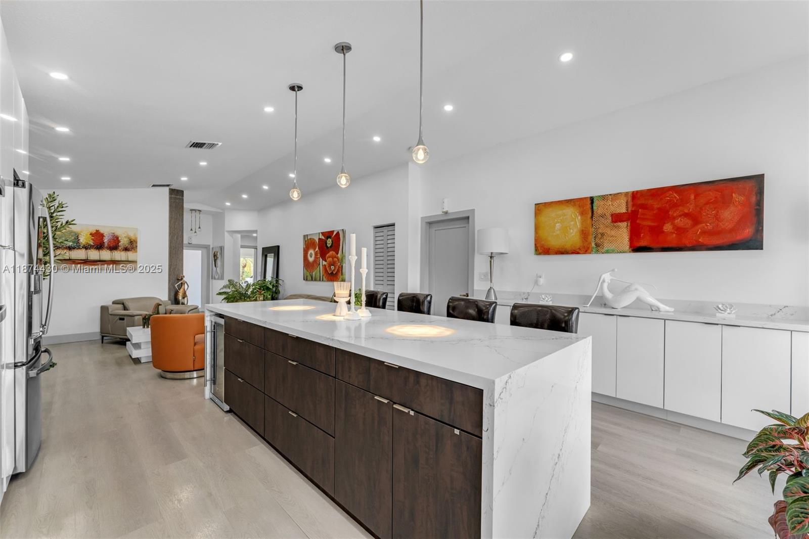 16300 Southwest 102nd Street Miami, FL 33196 - Photo 11 of 40 a large kitchen with stainless steel appliances kitchen island granite countertop a sink and cabinets
