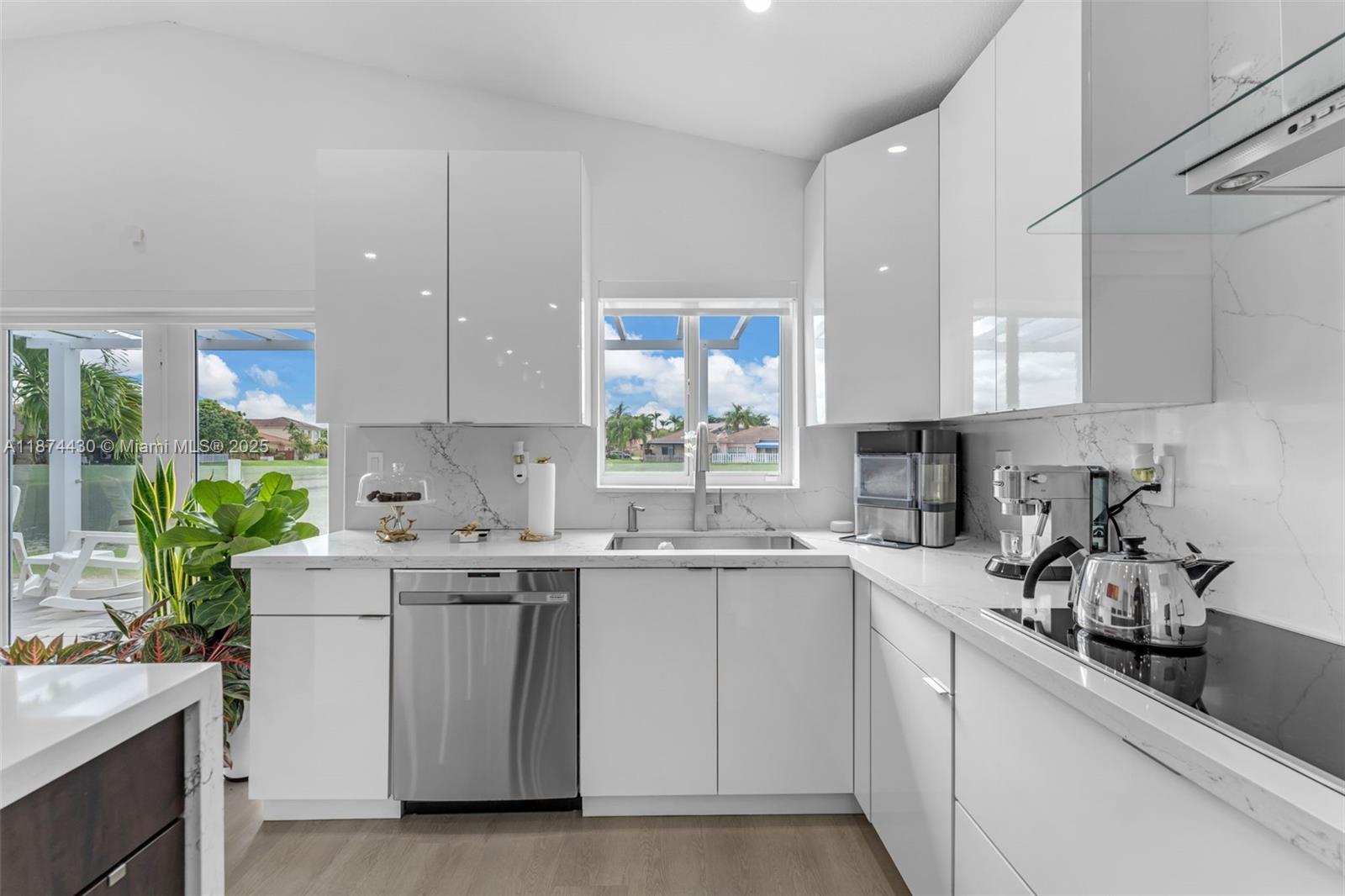 16300 Southwest 102nd Street Miami, FL 33196 - Photo 12 of 40 a kitchen with a sink stove and cabinets