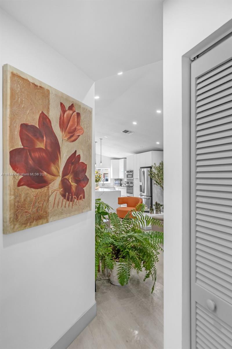 16300 Southwest 102nd Street Miami, FL 33196 - Photo 17 of 40 a view of a hallway with a couch and chandelier