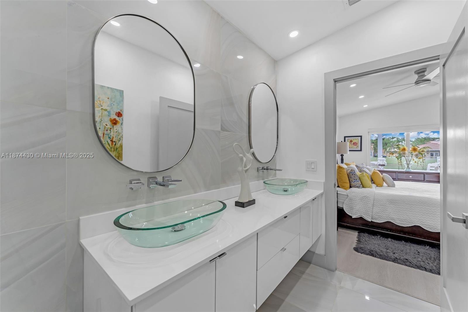 16300 Southwest 102nd Street Miami, FL 33196 - Photo 24 of 40 a en suite bathroom with a double vanity sink and a mirror