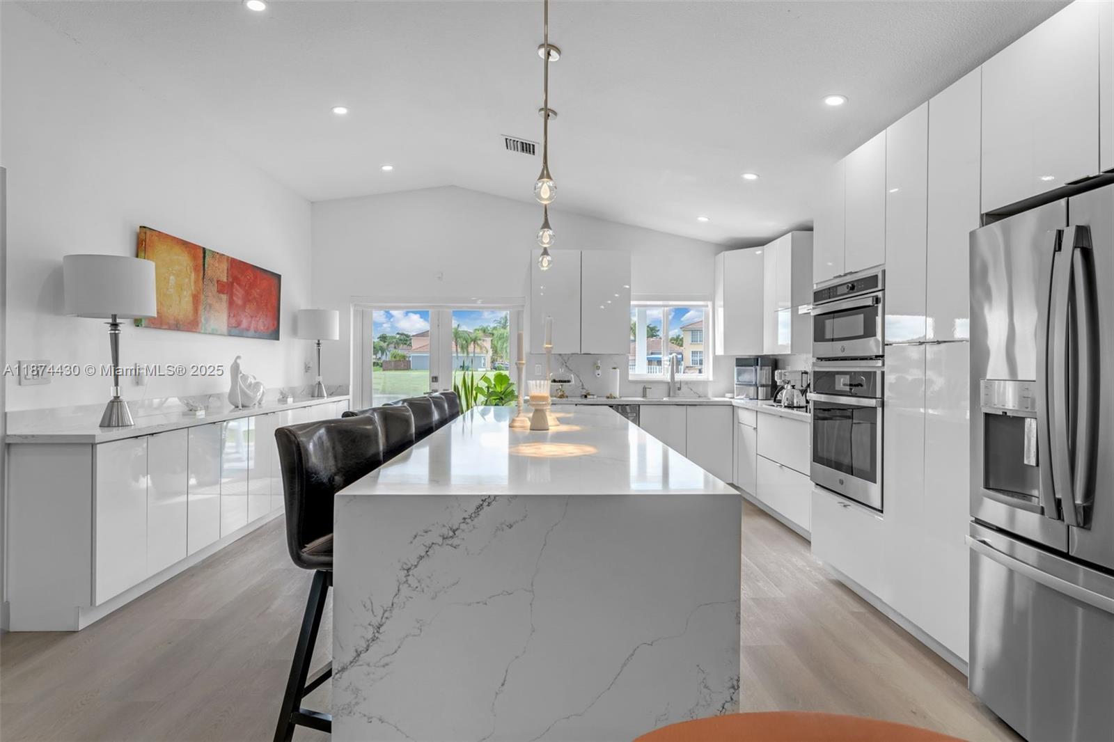 16300 Southwest 102nd Street Miami, FL 33196 - Photo 6 of 40 a large kitchen with stainless steel appliances granite countertop a sink a stove and a refrigerator