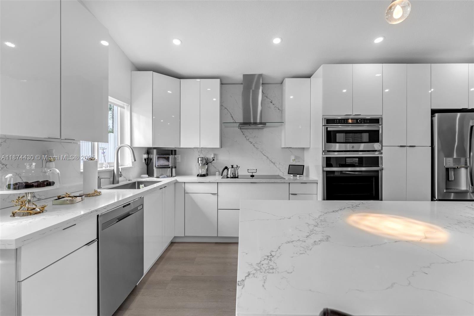 16300 Southwest 102nd Street Miami, FL 33196 - Photo 9 of 40 a kitchen with stainless steel appliances kitchen island granite countertop a stove sink and refrigerator