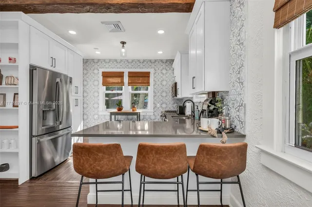 a view of a patio with a table and chairs under an umbrella