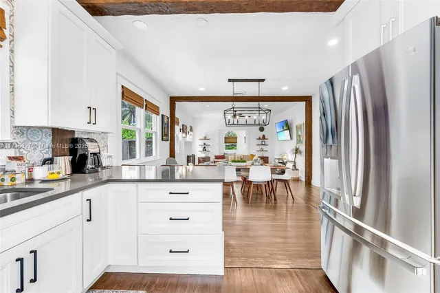 a view of house with backyard outdoor seating and hardwood