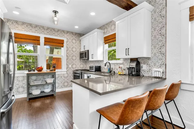 a backyard of a house with barbeque oven table and chairs