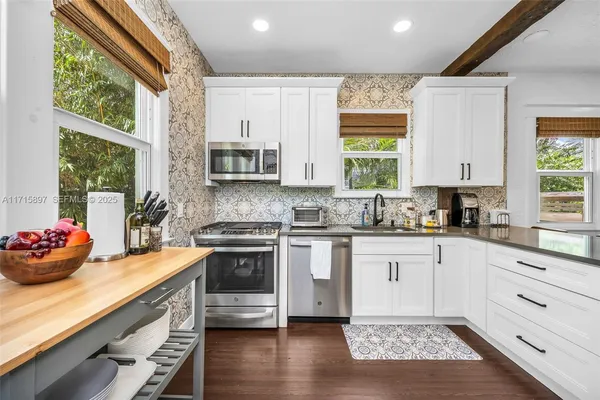 a bedroom with a bed and a view of kitchen