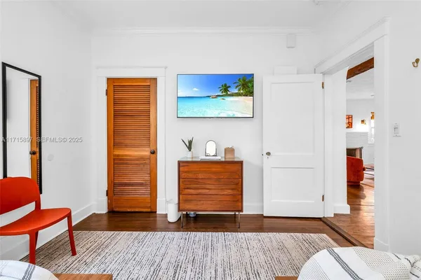 a view of a patio with a table and chairs under an umbrella