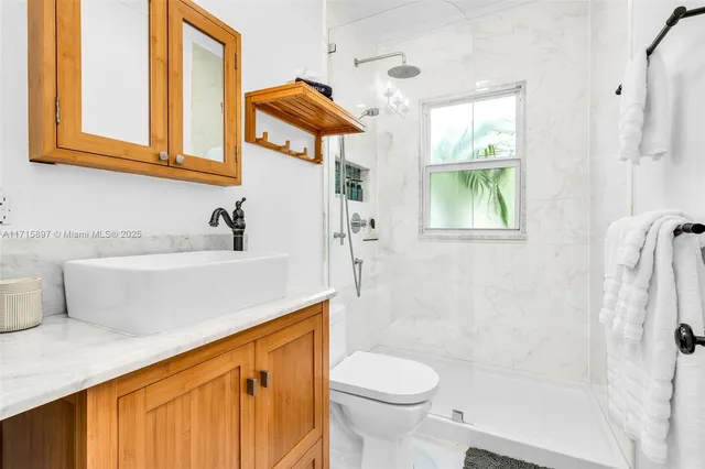 an aerial view of residential house with outdoor space and trees all around