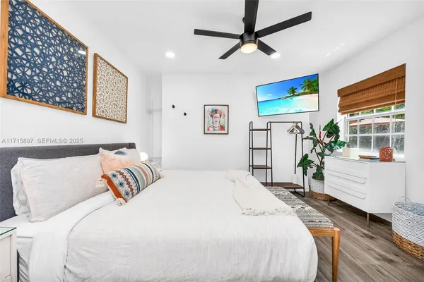 a palm tree sitting on the side of a road