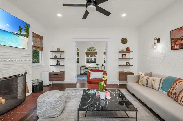 a kitchen with stainless steel appliances granite countertop a stove top oven a sink a dining table and chairs