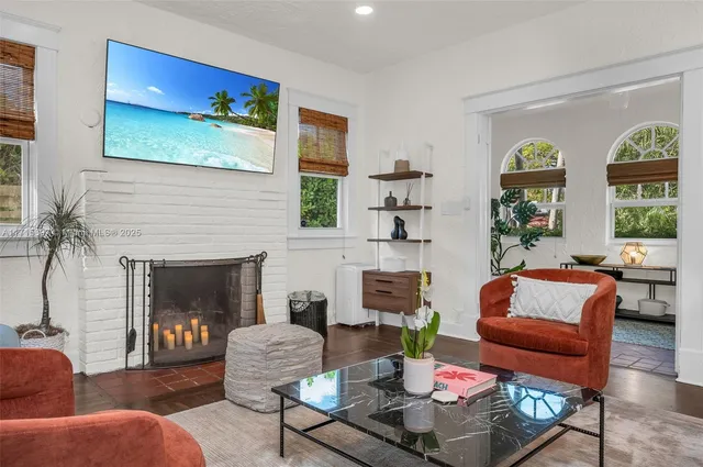 a kitchen with white cabinets and wooden floor
