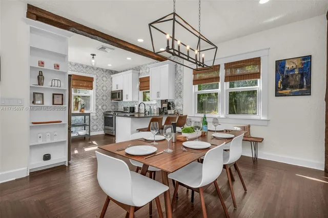a spacious bedroom with a bed a couch and a dresser next to a window