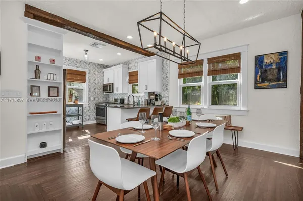 a kitchen with granite countertop kitchen island stainless steel appliances a refrigerator a sink and a stove