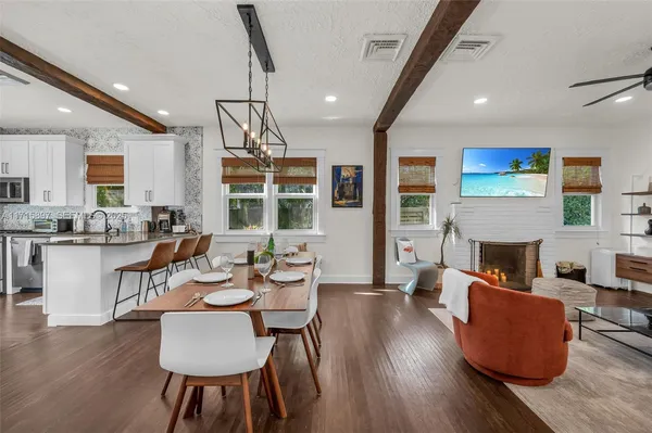 a kitchen with stainless steel appliances a stove a sink and white cabinets
