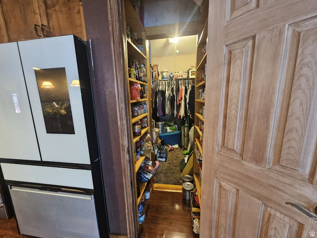 52 Quail Court Moab, UT 84532 - Photo 13 of 36 Walk-in closet with extensive built-in shelving, hanging rods, and wood-finish flooring