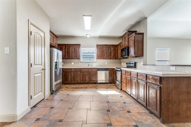 a kitchen with stainless steel appliances granite countertop a stove and a sink