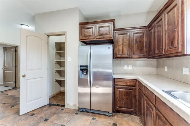 a kitchen with granite countertop a sink stove and cabinets