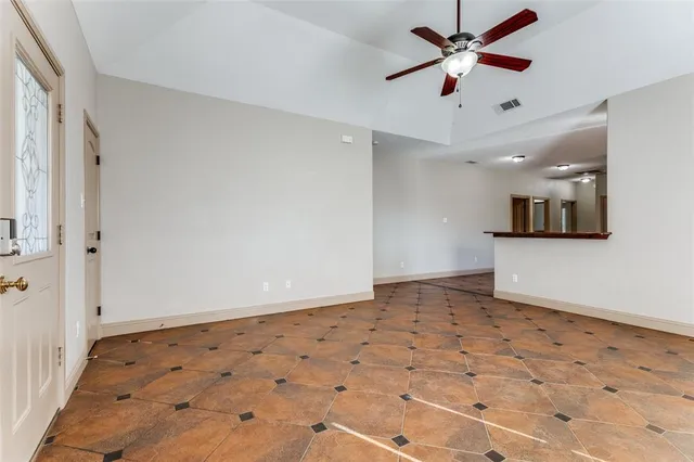 a view of a kitchen with refrigerator and windows