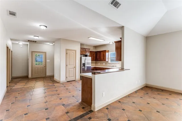 a view of a hallway with a refrigerator and a sink