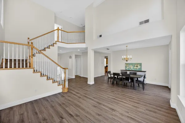 a view of a dining room with furniture and wooden floor