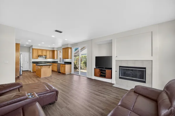 a living room with furniture fireplace and flat screen tv