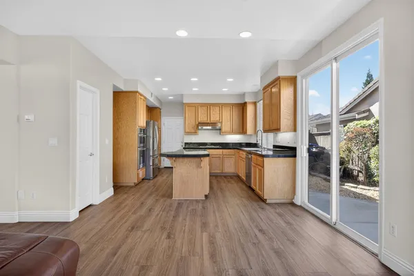 a kitchen with granite countertop white cabinets and stainless steel appliances