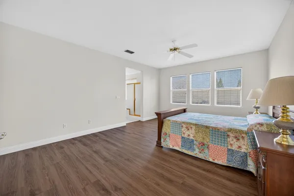 a bathroom with a granite countertop sink a toilet a mirror and shower