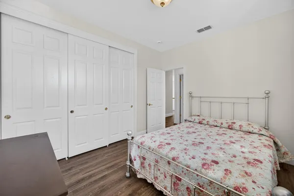 a bedroom with a bed a window and lamps