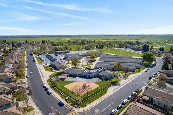 a view of a dining room with furniture floor to ceiling window and wooden floor