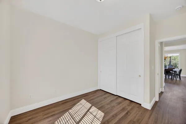 a view of an empty room and wooden floor