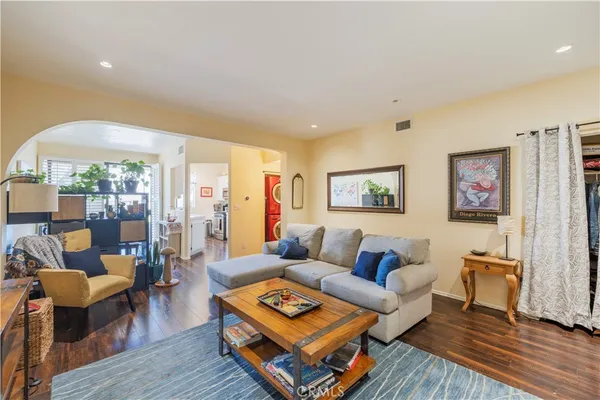 a living room with furniture and wooden floor