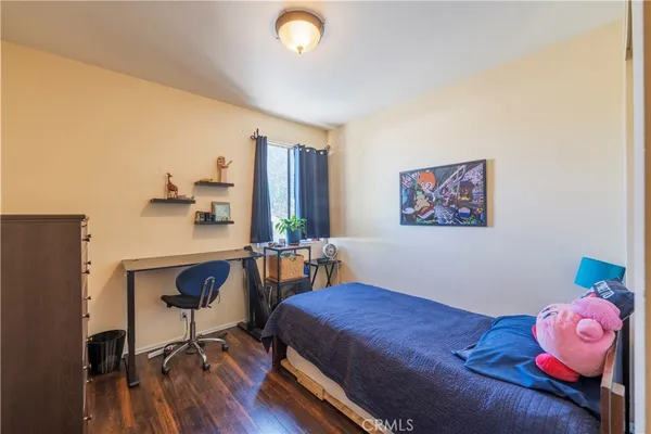 a bedroom with a bed and a workspace