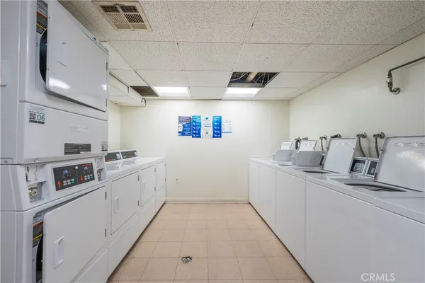 a kitchen with granite countertop a sink and white cabinets
