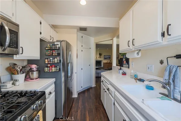 a kitchen that has a sink and a stove in it