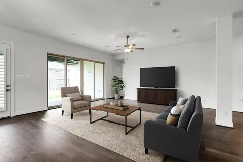 a view of a yard with porch and wooden fence