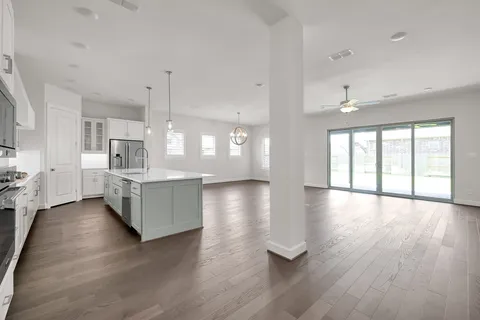 a kitchen with a refrigerator a stove and a sink