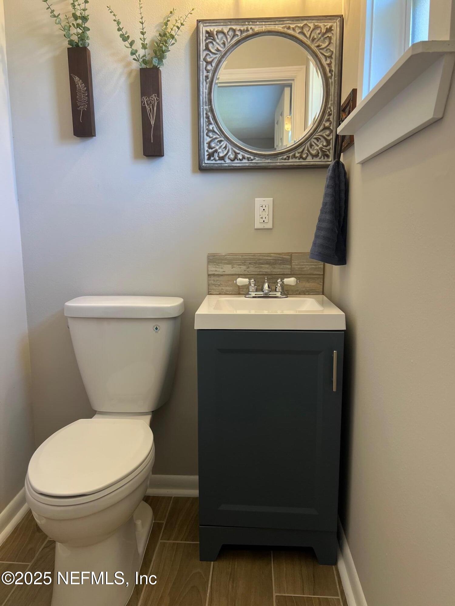 205 Noel Road Orange Park, FL 32073 - Photo 60 of 84 a bathroom with a toilet sink and mirror