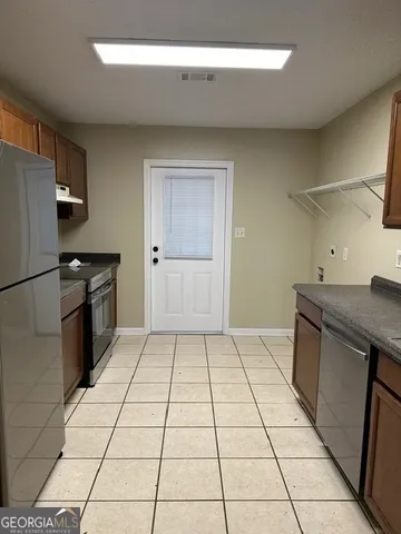 a kitchen with granite countertop cabinets and sink