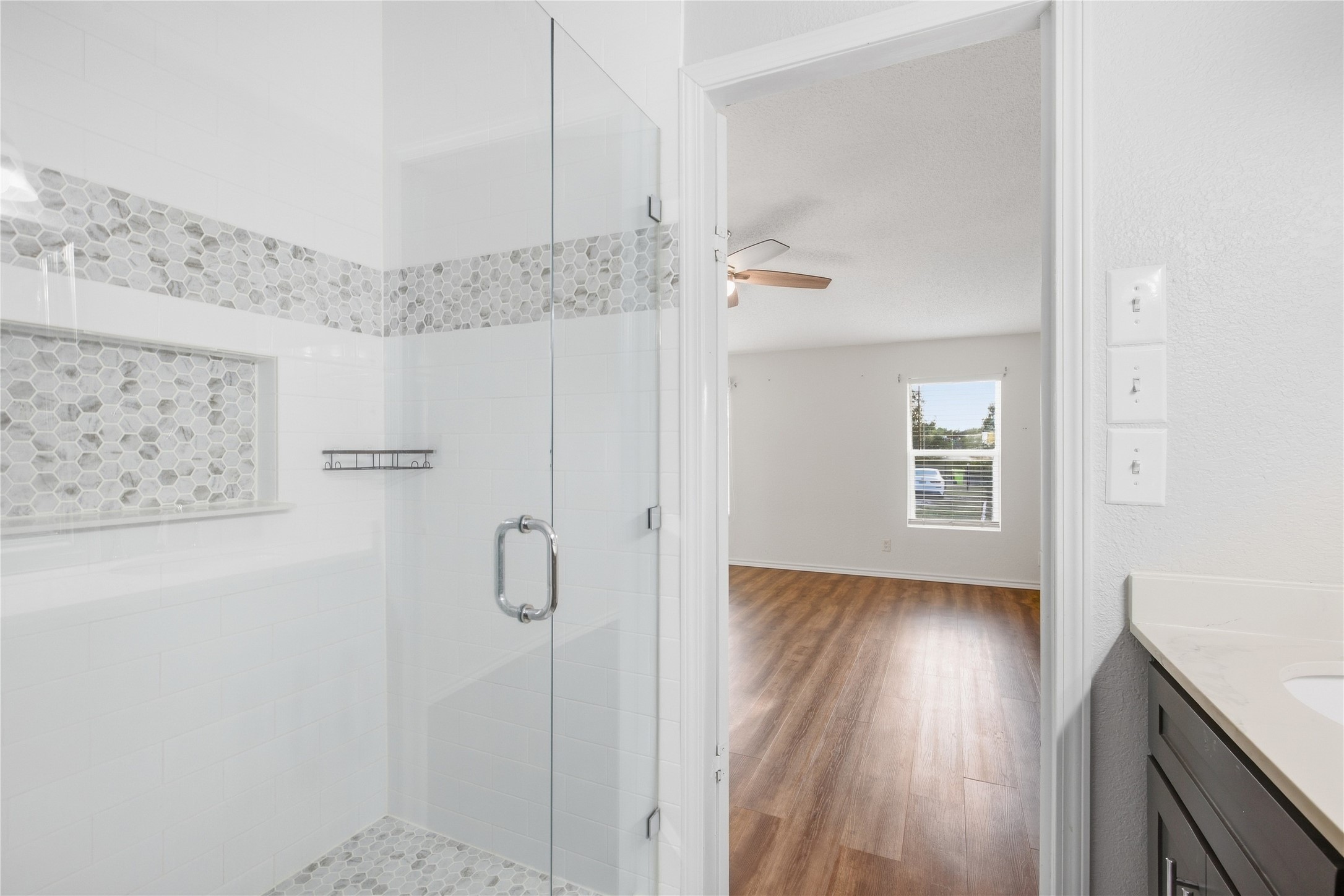 2709 County Road 463 Elgin, TX 78621 - Photo 11 of 32 An elegant walk-in shower features classic tile work and a seamless glass door.