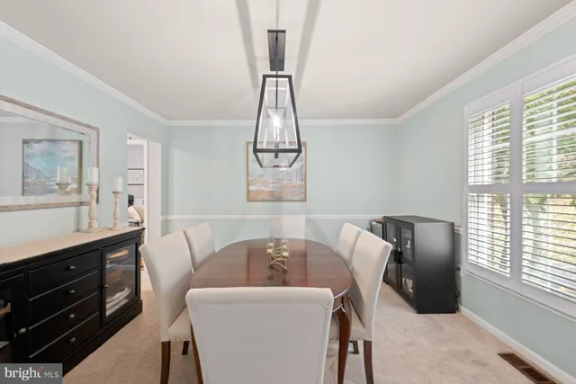 a view of a dining room with furniture and windows