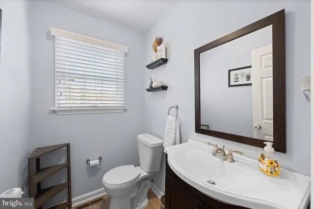 a bathroom with a sink toilet and mirror