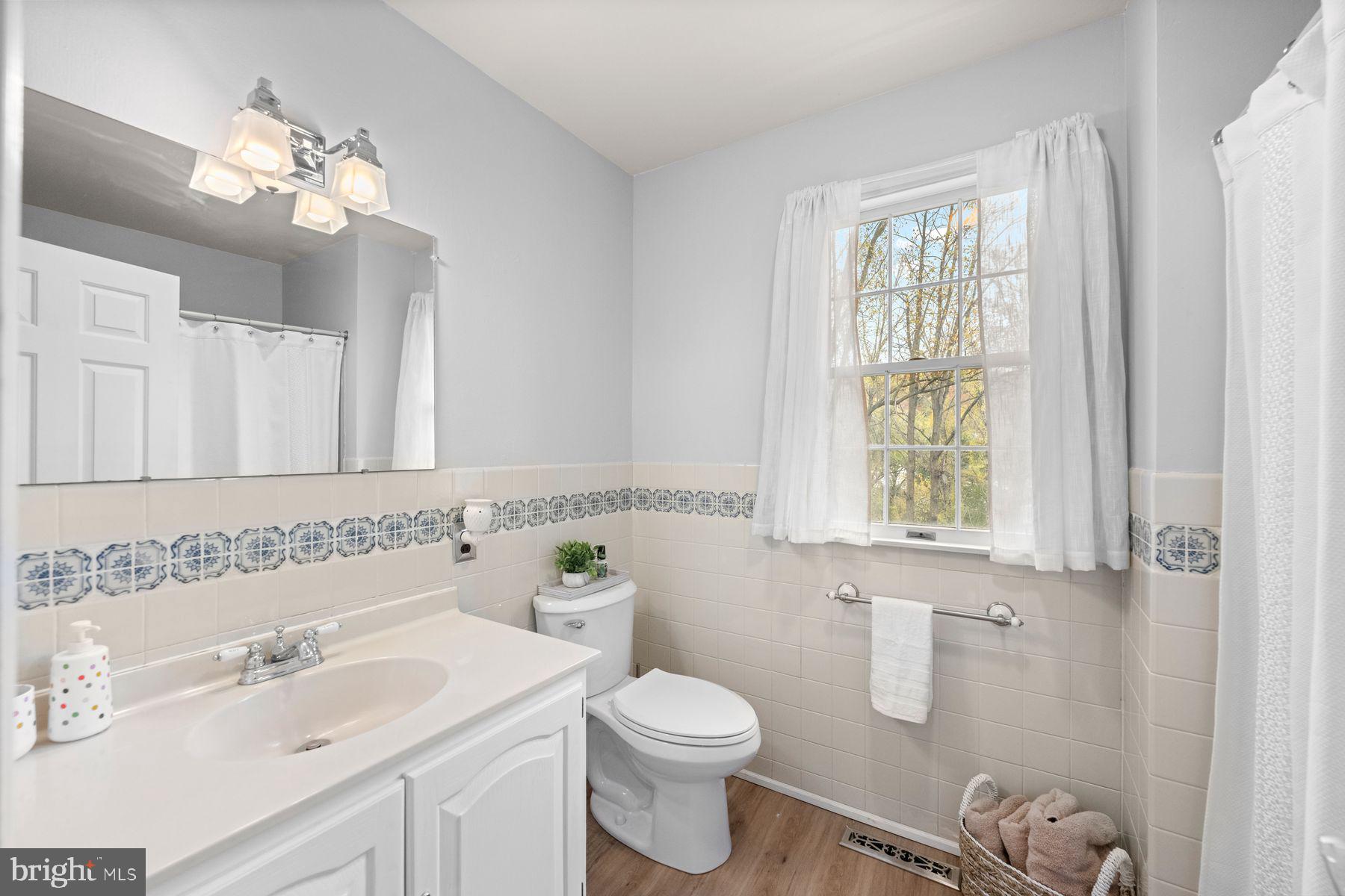 188 Arden Road Conshohocken, PA 19428 - Photo 25 of 39 a bathroom with a toilet a sink a mirror a window and vanity