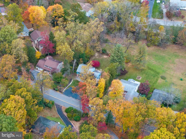 a aerial view of a house with swimming pool and garden