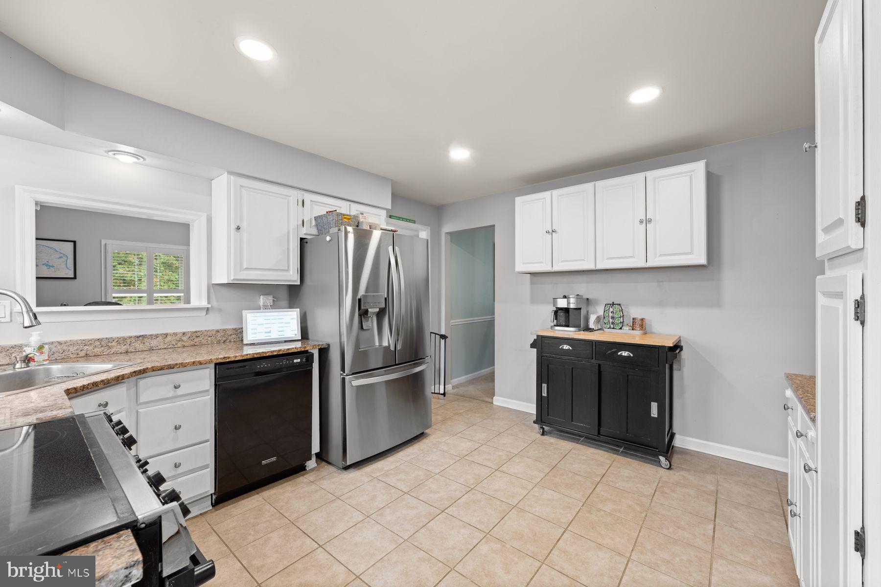 188 Arden Road Conshohocken, PA 19428 - Photo 4 of 39 a kitchen with granite countertop a refrigerator and a stove top oven