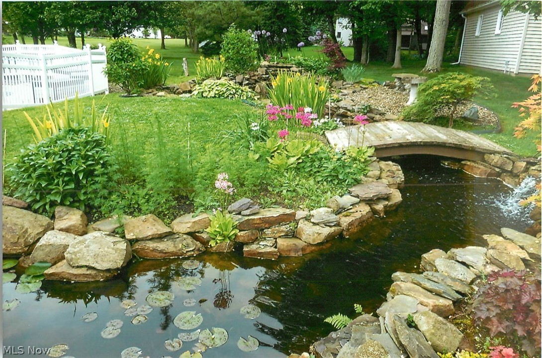 8451 Rockefeller Lane Northfield, OH 44067 - Photo 32 of 35 The pond flows under a bridge and over two waterfalls to a lower pond.