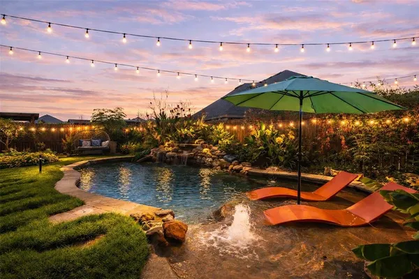 an aerial view of a house with swimming pool outdoor seating and yard