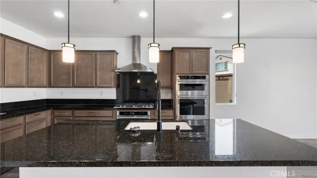 a kitchen with kitchen island a counter top space appliances and cabinets