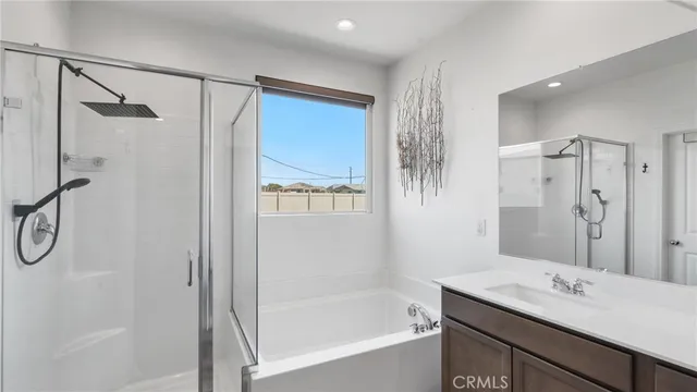 a bathroom with a shower sink vanity and mirror
