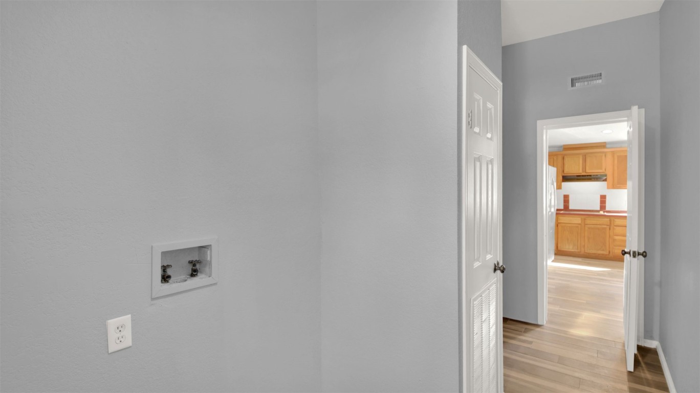 120 Webberwood Way Elgin, TX 78621 - Photo 19 of 36 Laundry room featuring hookup for a washing machine and light wood-type flooring