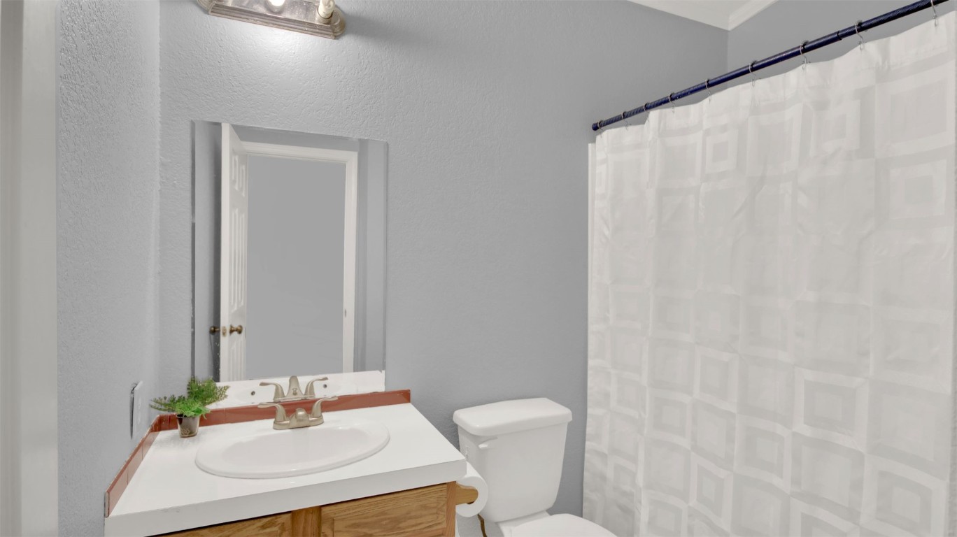 120 Webberwood Way Elgin, TX 78621 - Photo 22 of 36 Full bathroom with a shower with shower curtain, vanity, and a textured wall